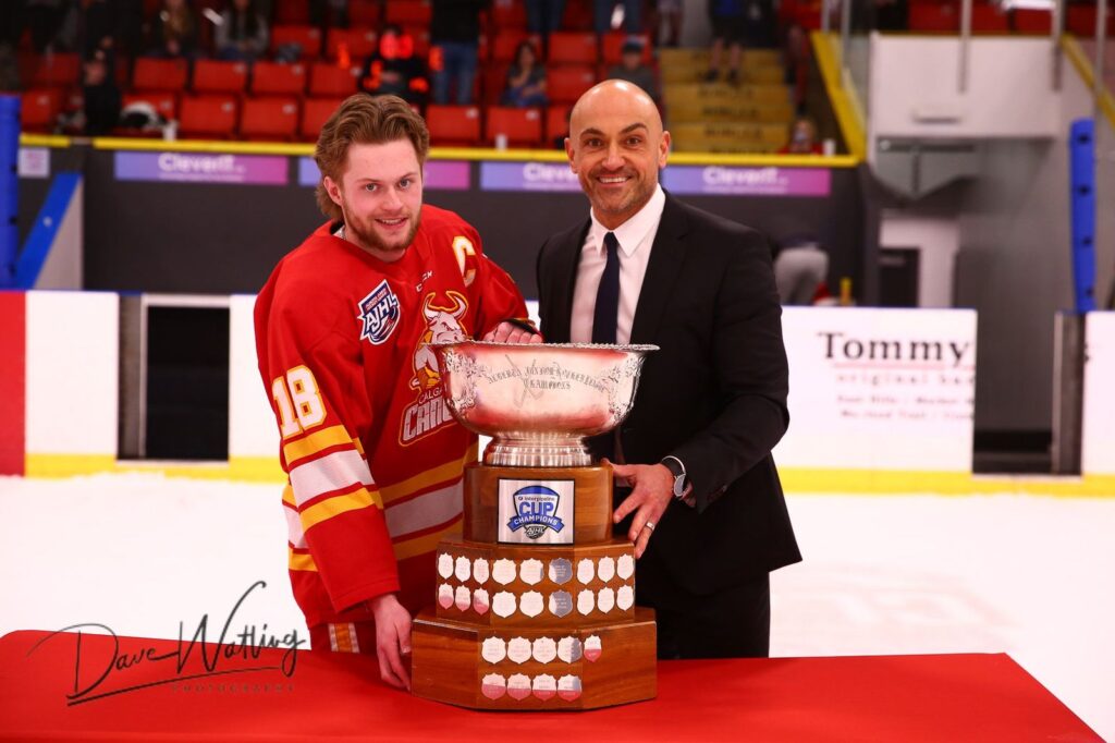 AJHL Commissioner Ryan Bartoshyk and Calgary Canucks Captain Bowden Singleton with the 2024 AJHL Championship Cup